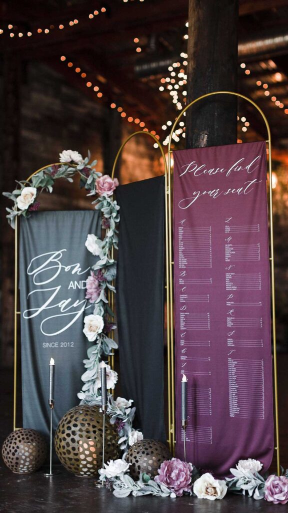Fabric seating chart and welcome sign at wedding reception